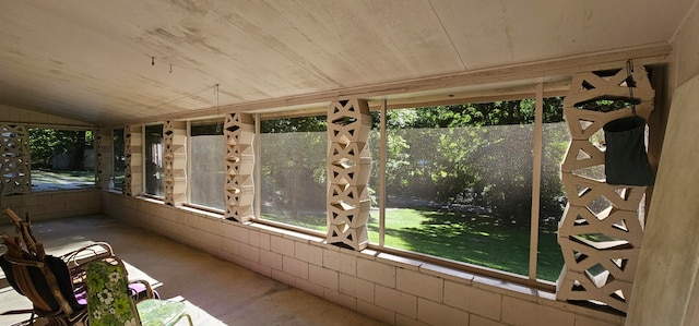 unfurnished sunroom with lofted ceiling and a healthy amount of sunlight