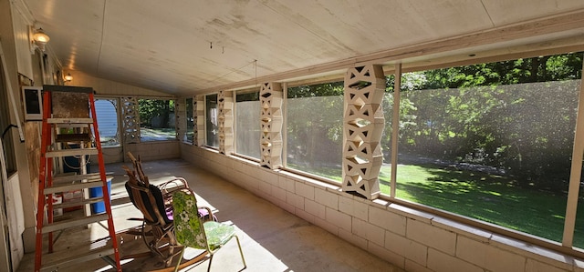 unfurnished sunroom featuring lofted ceiling