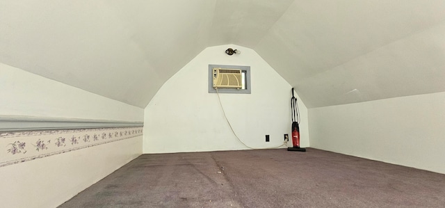 bonus room with carpet flooring, a wall mounted air conditioner, and vaulted ceiling