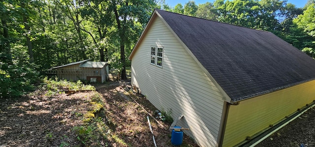 view of side of property featuring a shed