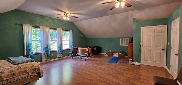 interior space featuring dark wood-type flooring, lofted ceiling, and ceiling fan