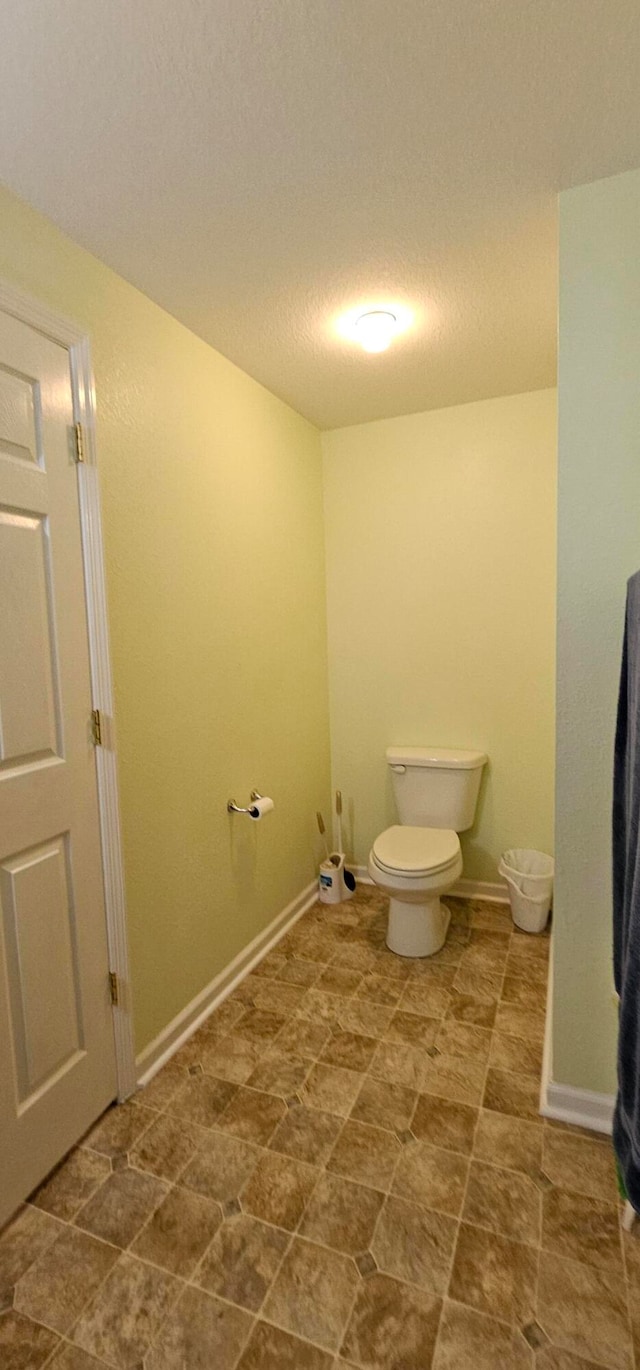 bathroom featuring toilet and a textured ceiling