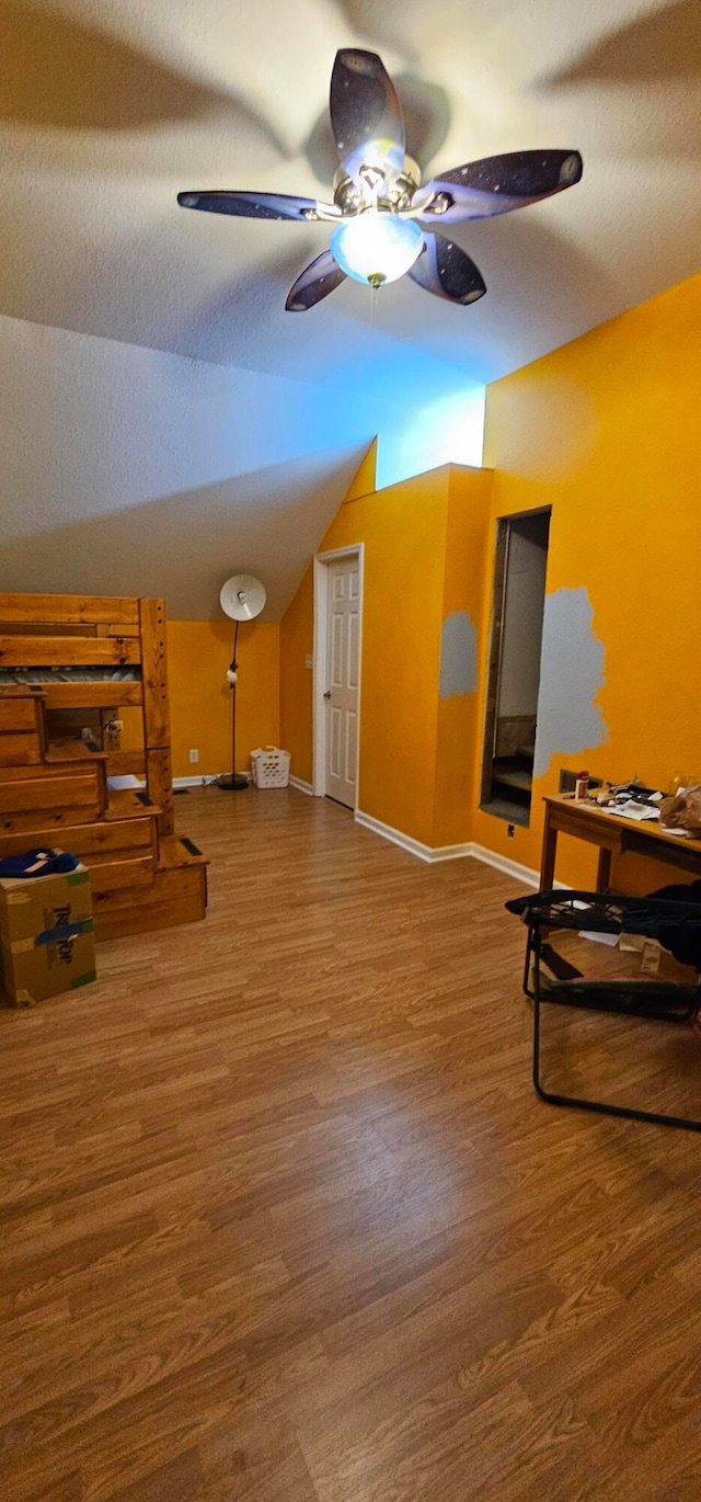 interior space with lofted ceiling, ceiling fan, and hardwood / wood-style flooring