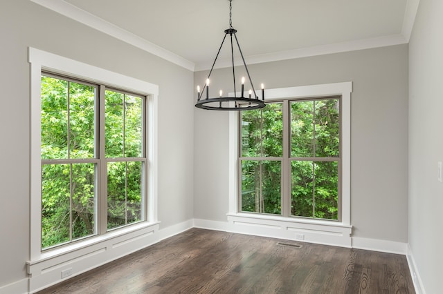 unfurnished dining area featuring visible vents, dark wood-style flooring, baseboards, and ornamental molding