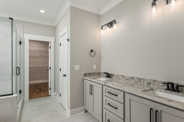 bathroom featuring a shower with shower door, wood-type flooring, ornamental molding, and vanity