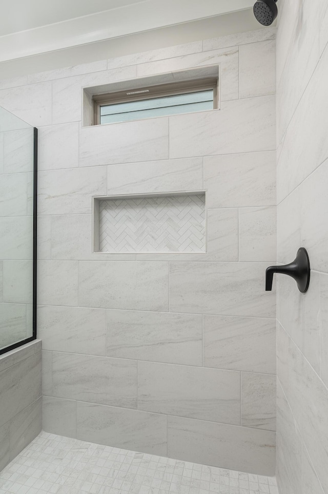 bathroom with a tile shower