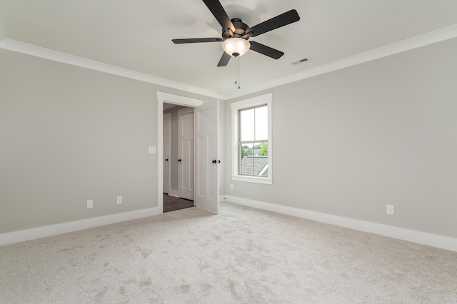 unfurnished bedroom with carpet flooring, ceiling fan, and ornamental molding