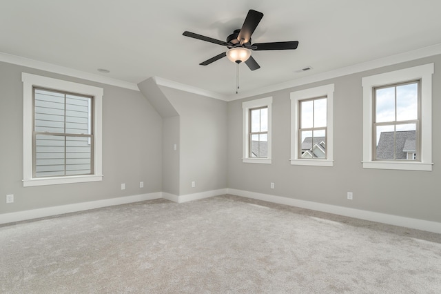 carpeted empty room featuring a ceiling fan, baseboards, and ornamental molding