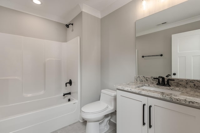 full bathroom featuring toilet, tile patterned floors, ornamental molding, vanity, and bathing tub / shower combination