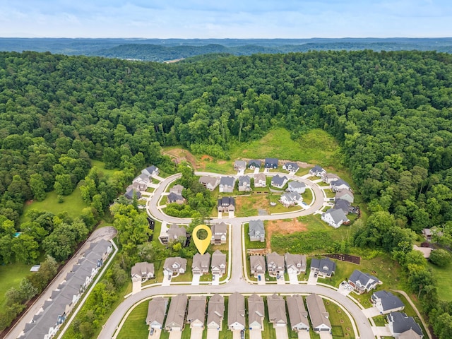 birds eye view of property featuring a residential view and a wooded view