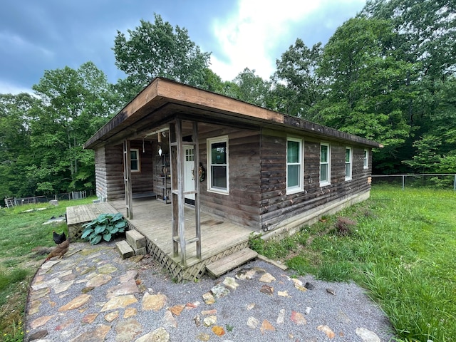 view of side of home with a yard