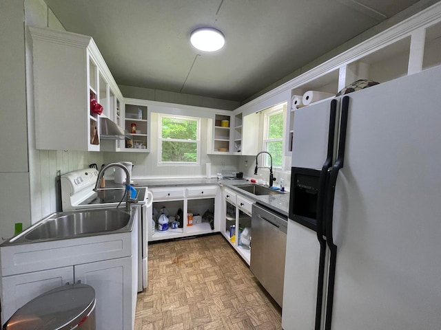 kitchen with white cabinets, dishwasher, white refrigerator with ice dispenser, sink, and light parquet floors