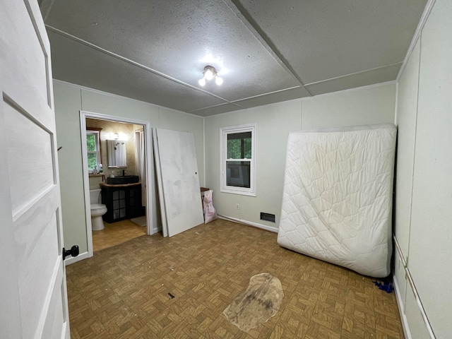 interior space featuring parquet floors and a healthy amount of sunlight