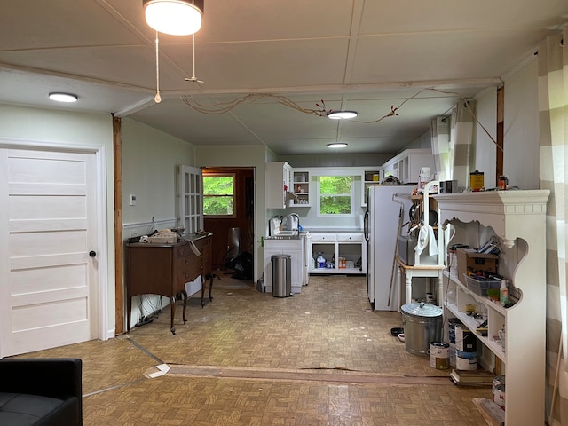 interior space featuring white cabinets and white fridge