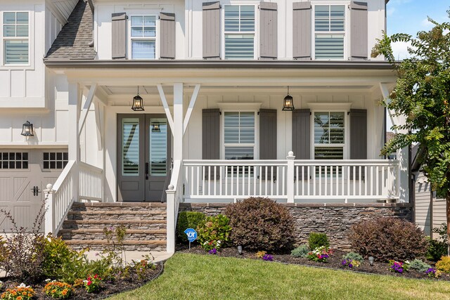 doorway to property featuring a porch and a garage