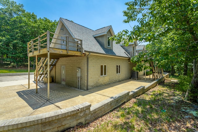 rear view of house with a patio area, a deck, and central air condition unit