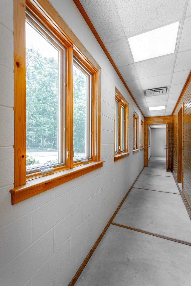 hallway with a paneled ceiling