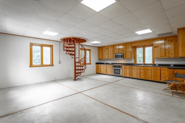 kitchen featuring stainless steel appliances, sink, and a drop ceiling