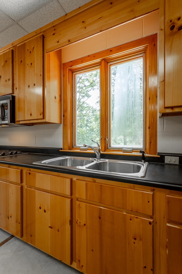 kitchen featuring a drop ceiling and sink