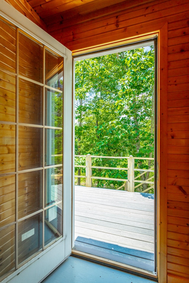 entryway featuring wood walls