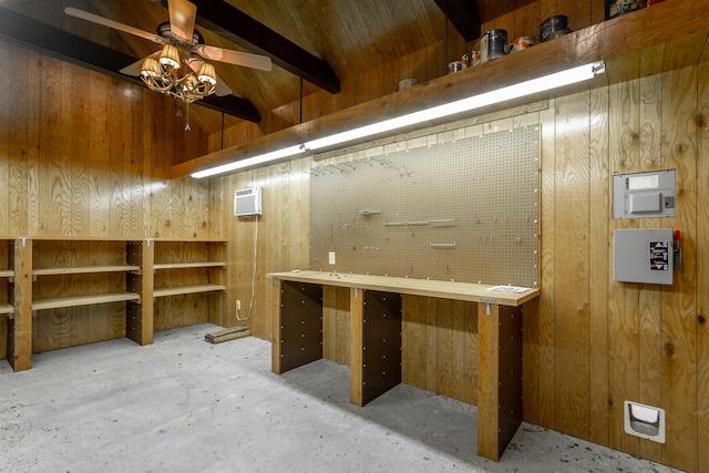 interior space with ceiling fan, wooden walls, and a workshop area