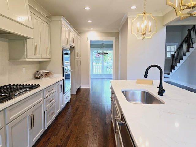 kitchen featuring an inviting chandelier, stainless steel appliances, premium range hood, dark wood-type flooring, and pendant lighting