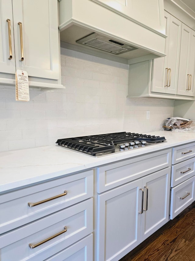 kitchen with white cabinetry, dark hardwood / wood-style flooring, and stainless steel gas stovetop