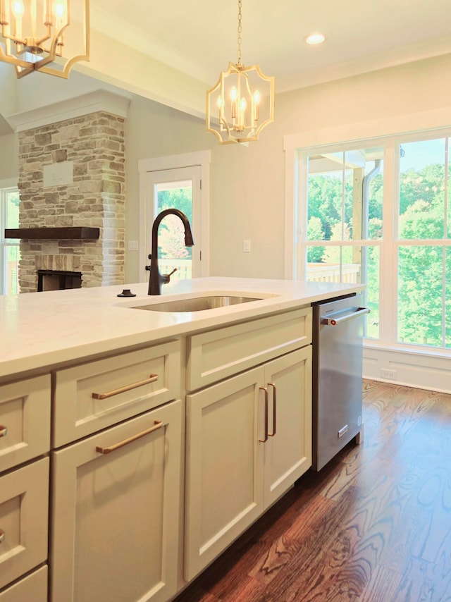 kitchen with dishwasher, dark hardwood / wood-style flooring, sink, and a notable chandelier