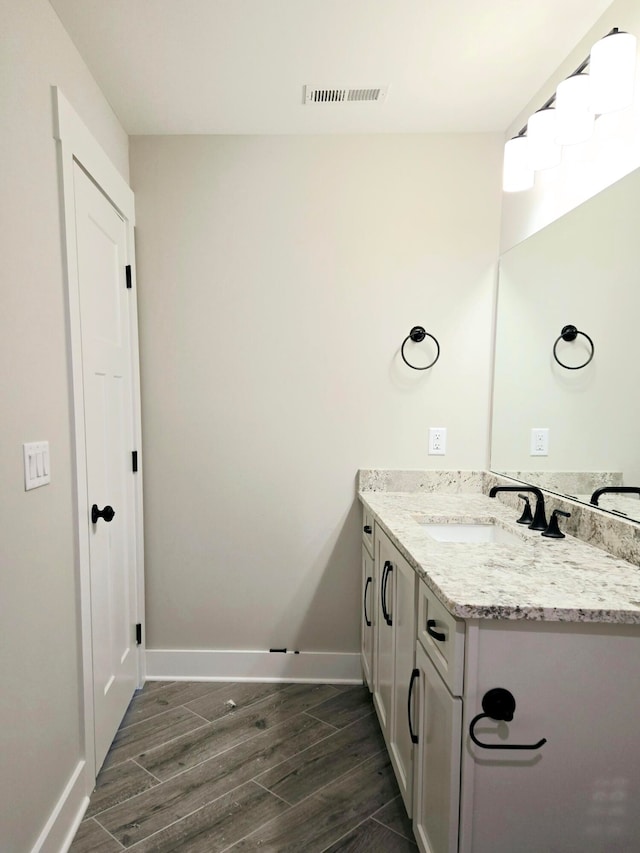 bathroom with vanity and hardwood / wood-style flooring