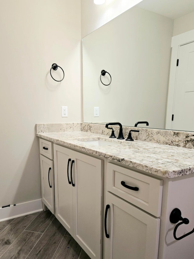 bathroom featuring vanity and hardwood / wood-style floors