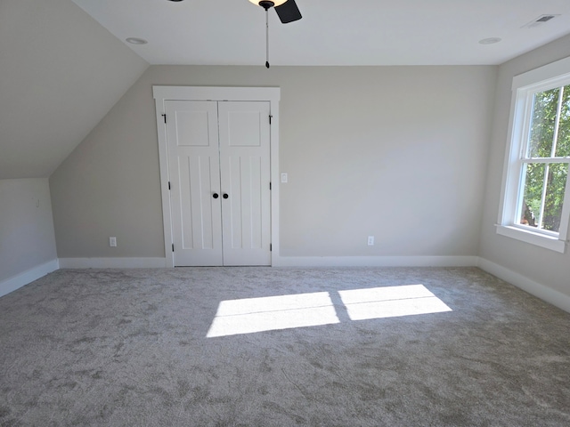 additional living space with light carpet, lofted ceiling, and ceiling fan