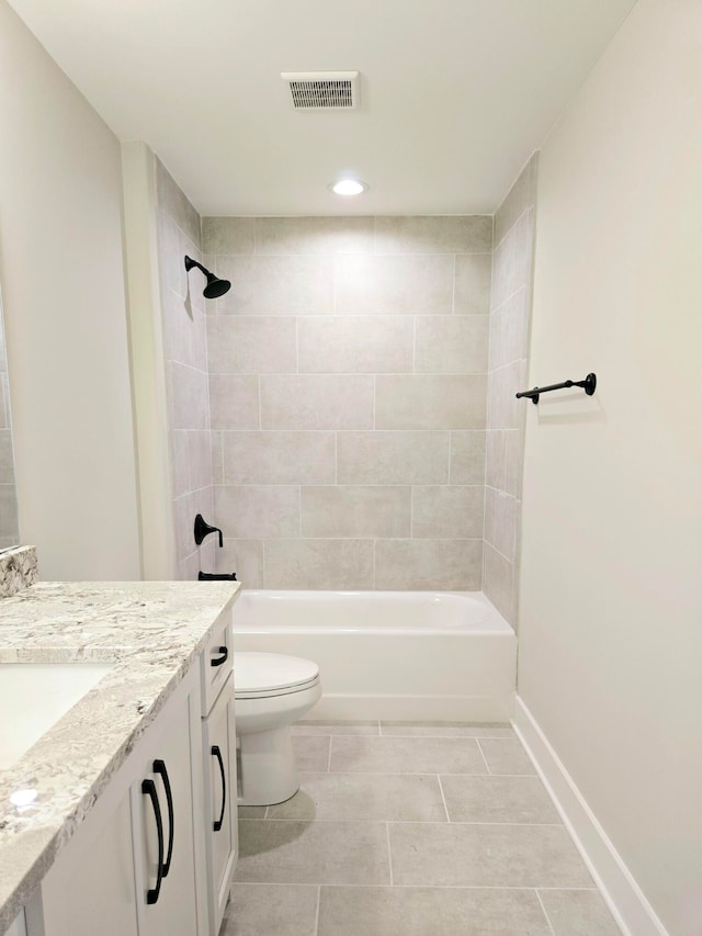 full bathroom with tile patterned floors, tiled shower / bath, toilet, and vanity