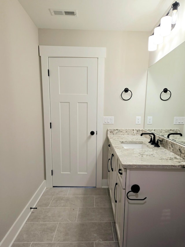 bathroom with vanity and tile patterned floors