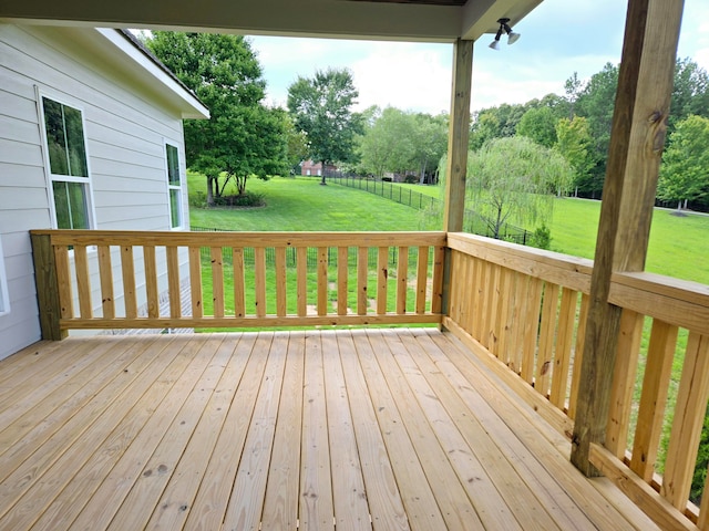 wooden terrace with a lawn