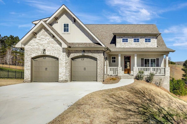 craftsman inspired home featuring concrete driveway, a porch, board and batten siding, and a shingled roof