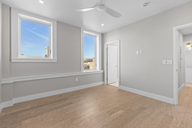 unfurnished room featuring recessed lighting, wood finished floors, baseboards, and ceiling fan