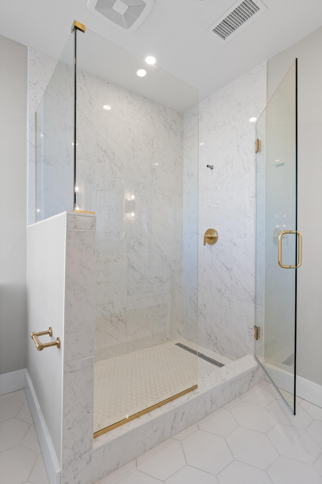 bathroom with tile patterned flooring and a shower with shower door