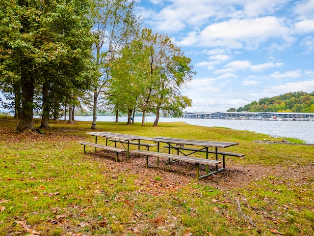 view of home's community featuring a water view and a lawn