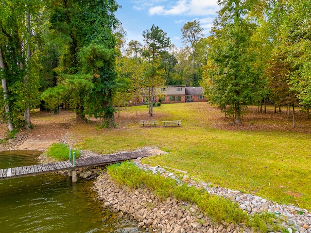 exterior space with a water view and a yard