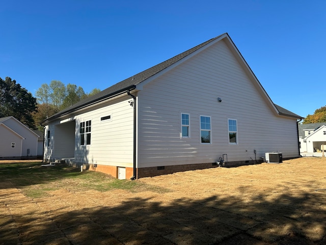 rear view of house featuring central air condition unit