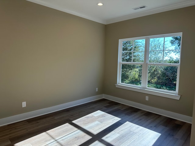 unfurnished room with ornamental molding and dark hardwood / wood-style flooring