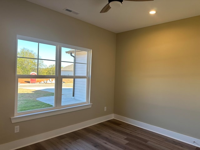 unfurnished room with ceiling fan and dark hardwood / wood-style flooring