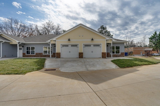 ranch-style house featuring a garage and a front lawn