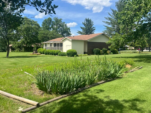 view of property exterior with a lawn