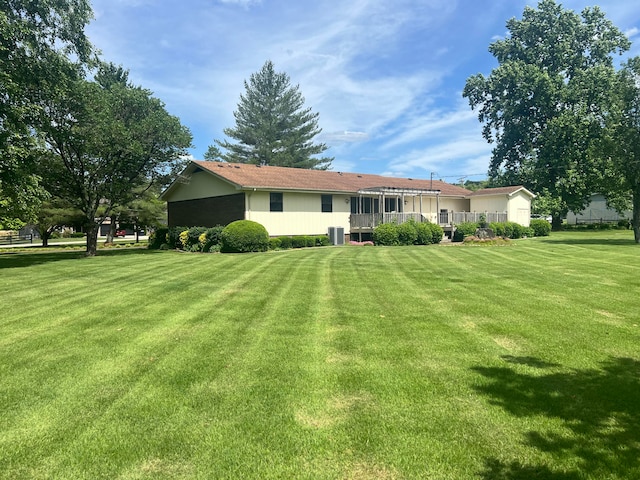 back of property featuring a yard and central air condition unit