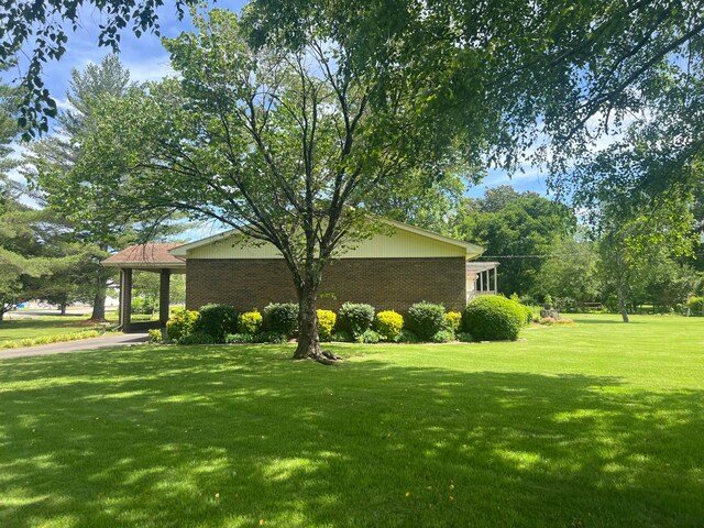 view of property exterior with a yard