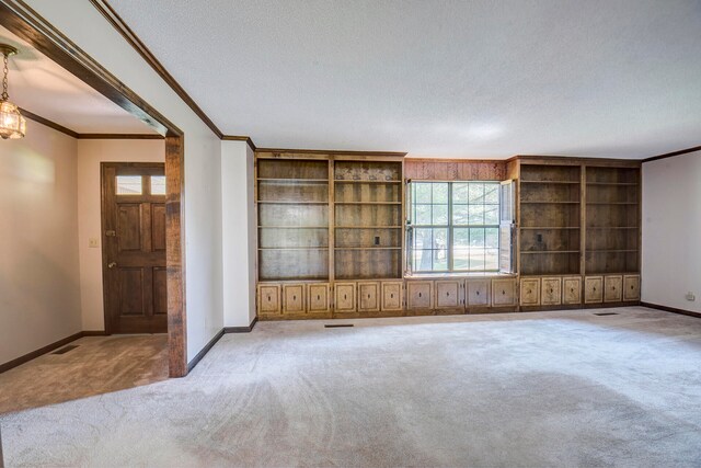 unfurnished living room with light carpet, crown molding, and a textured ceiling