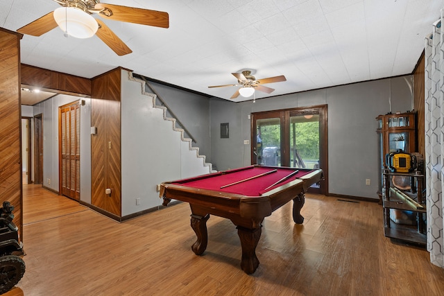 game room with hardwood / wood-style floors, pool table, ceiling fan, and wooden walls