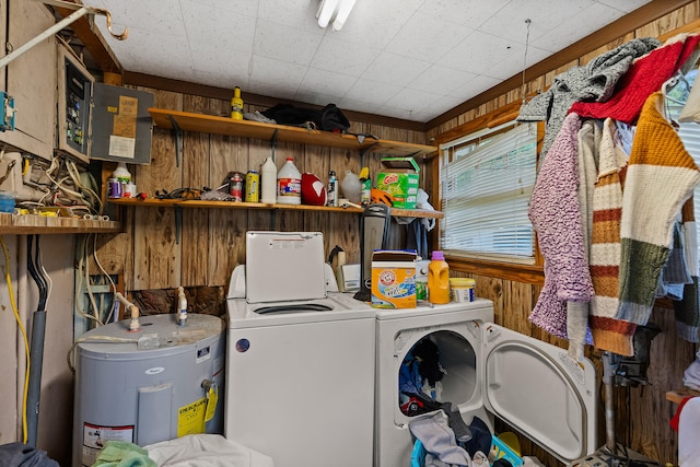 laundry room featuring separate washer and dryer, electric water heater, and wooden walls