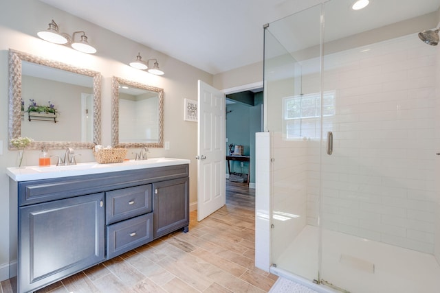 bathroom with vanity, hardwood / wood-style floors, and an enclosed shower